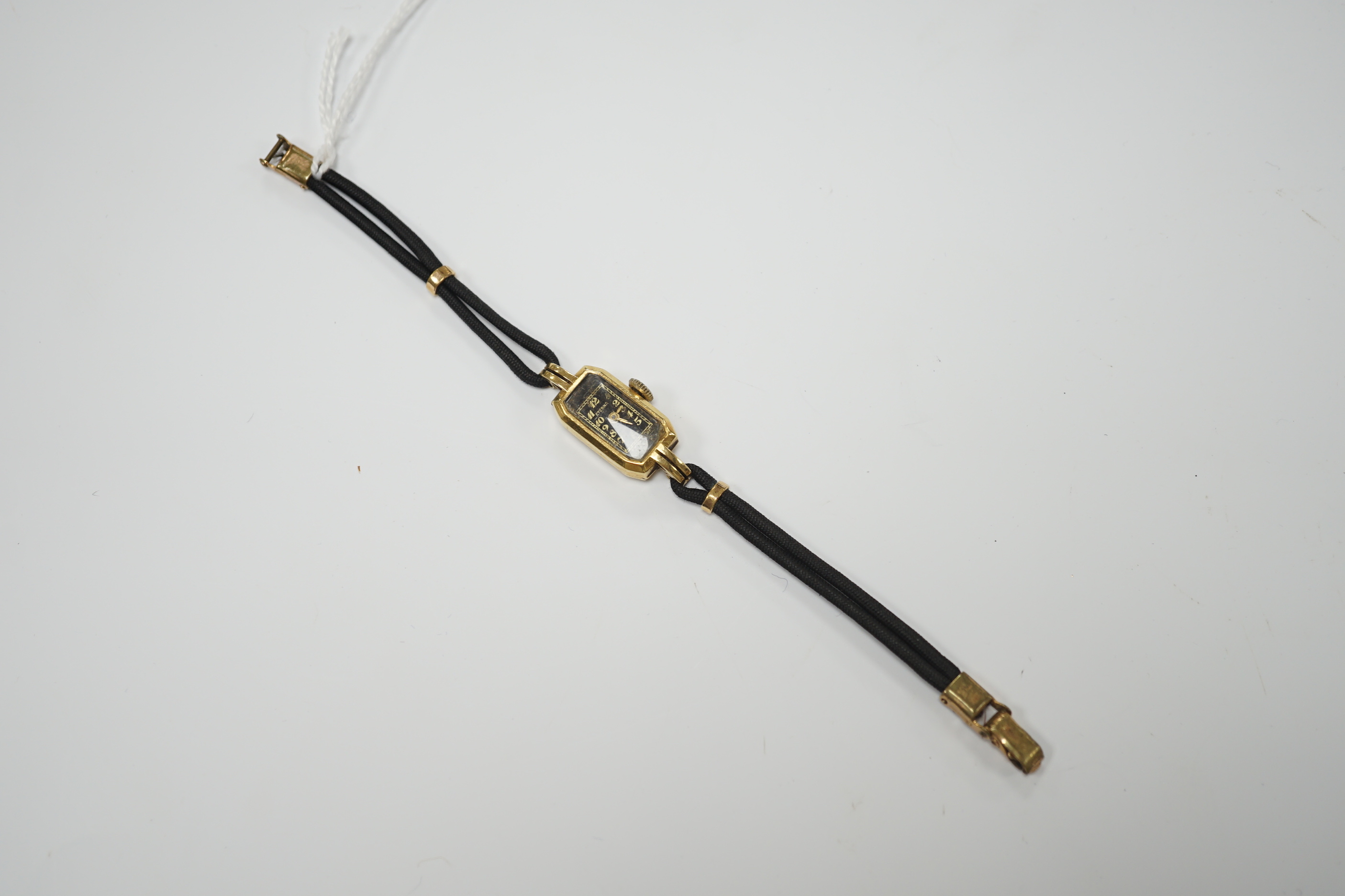 A lady's 1930's 18ct gold Eterna manual wind wrist watch, on a twin strand fabric strap with gold plated clasp